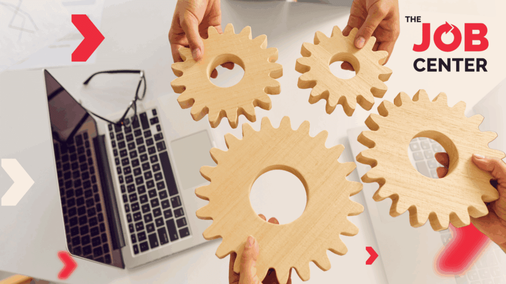4 hands hold wooden gears beside a laptop and glasses, symbolizing workforce planning for peak season.