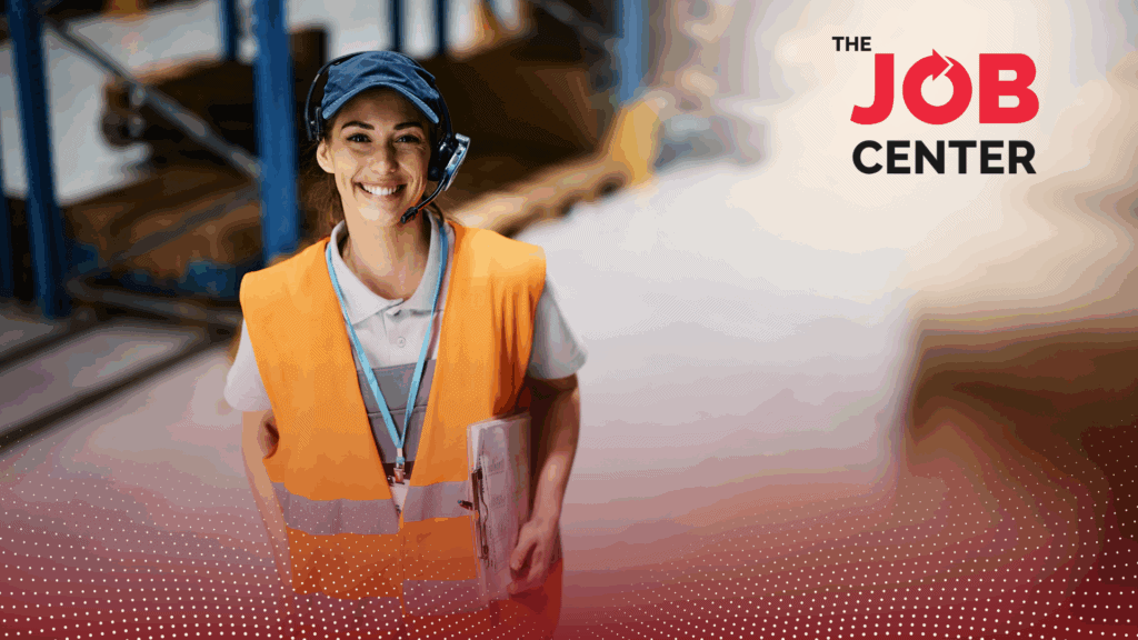 Warehouse worker in logistics stands wearing safety vest and headset, holding a clipboard