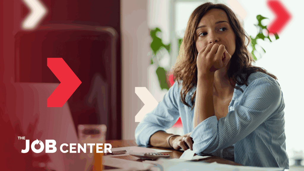 Stressed recruiter sits at her desk with chin in hand